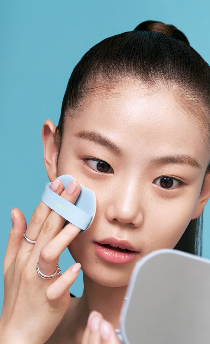 Model applying makeup with Neo Cushion Mewy